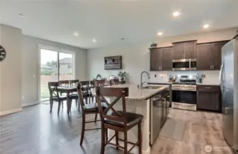 Spacious kitchen/eating area. Stainless appliances, gas range and a large island with additional eating space. Granite counters are lovely.