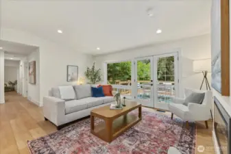 Spacious and bright living room with beautiful LVT flooring opens up to a brand new cedar deck.