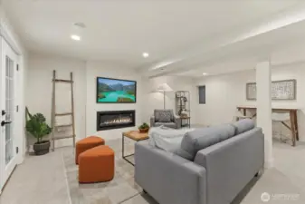 Downstairs family room with electric fireplace and bar area.  Perfect for family activities or entertaining.