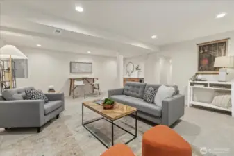 Downstairs family room with electric fireplace and bar area.