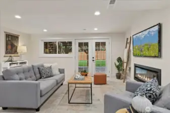 Downstairs family room with electric fireplace and bar area.  Opens out to the back yard.