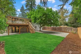 Large, grassy yard with new sod and a beautiful cedar deck connected to the living room for indoor/outdoor living.