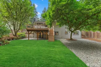 Large, grassy yard with new sod and a beautiful cedar deck connected to the living room for indoor/outdoor living.