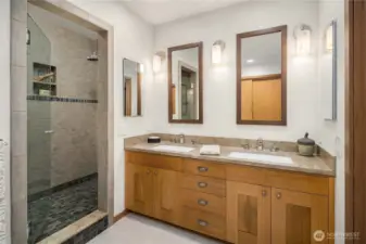Primary walk-in shower and double sinks.
