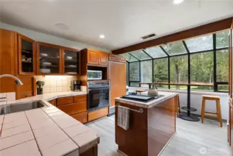 Kitchen has beautiful cabinetry, center island & eating bar