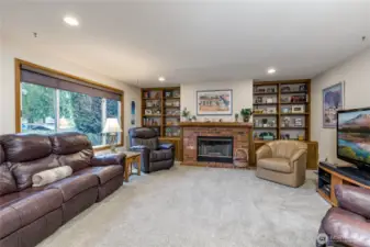 Family room features built-in shelving and a cozy gas fireplace