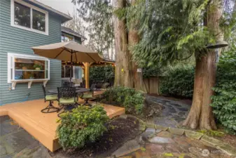Beautiful wooded corner of the property with flagstone patios and walkways