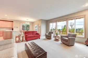 This lovely living room has a cozy gas fireplace, wall of windows for sunset, city light, golf course, sound and Olympic Mountain views. This great open floor plan includes the kitchen and eating nook.