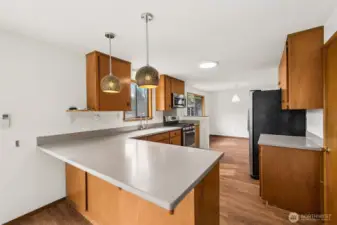 Updated kitchen with gas range, breakfast bar & all appliances stay.