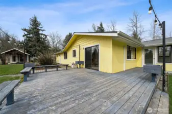 Oversized wraparound deck with darling outbuilding in the distance