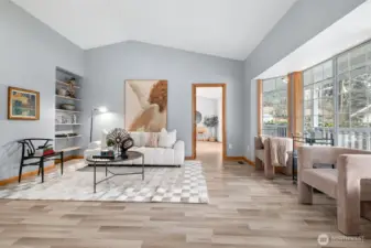 Spacious living room with cathedral ceilings and large windows.