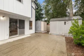 Huge patio . Dog run on the side of the house adjacent to the smaller shed.