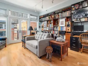 One wall of the main living area has built-in bookshelves with desk area that can stay or be removed