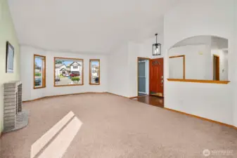 Vaulted ceilings and natural light pouring thru the large windows gives this formal living room a very open feeling!