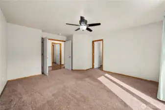 Primary bedroom with double doors en suite bath and sliding door leading to back deck.