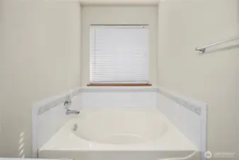 Soaking tub in the primary bedroom