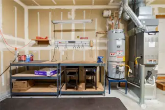Gas hot water and furnace in garage, work bench stays.