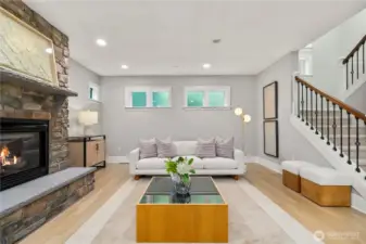 Living room with a cozy fireplace and privacy glass windows