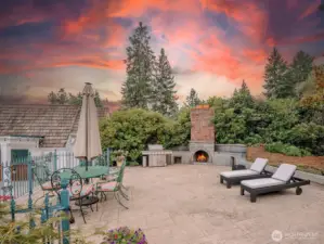 A large stone terrace between the main house and the boathouse. An outdoor fireplace makes this a great gathering place for family and friends