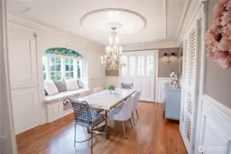 A bay window kickout with pillow seating adds charm to this light-filled space.
