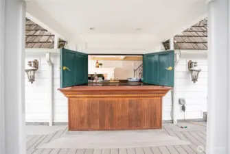 The exterior bar with doors that open to the interior kitchenette.