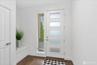 Storage sitting bench and hallway closet makes the entryway easy to keep organized!
