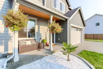 Covered front porch with cedar detail and craftsman garage doors just set the curb appeal of this Richmond American home - wait til you see inside!