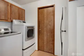 The Utility Room is off of the carport entry; door in the middle leads to the hall bathroom.