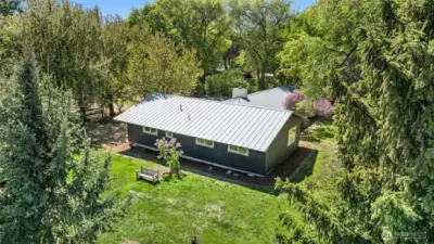 Metal roof and mature landscaping