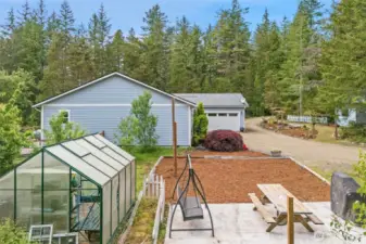 Green house is close to the house for easy access.