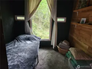 bedroom with view of the trees, a bigger bed could easily fit in this room