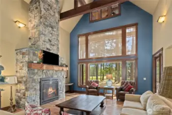 Floor to ceiling stone fireplace and soaring windows