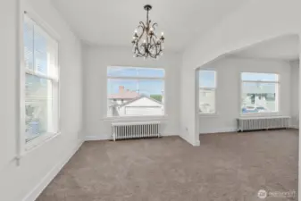 Upper-level dining area with living room to the right.