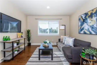 The spacious upstairs loft offers a versatile retreat for movie nights, gaming, or a home gym. Natural light pours through wide windows, and rich hardwood floors flow throughout. Neutral walls provide flexibility for any style, while recessed lighting and open layout make this loft an inviting space for everyone.