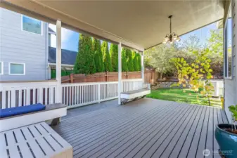 Enjoy year-round entertaining on the fully covered deck with built-in benches and overhead lighting. This spacious outdoor area easily fits a dining set or sectional, making it ideal for gatherings or quiet evenings outdoors.