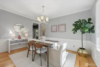 Formal dining room offers crown molding, hardwoods, wainscoting & a beautiful view to the covered front porch and beautiful, professional landscape!