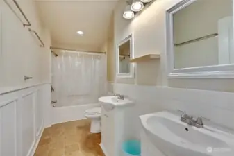 Full updated bathroom with double sinks.