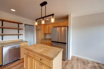 Large kitchen with stainless appliances and handy island.