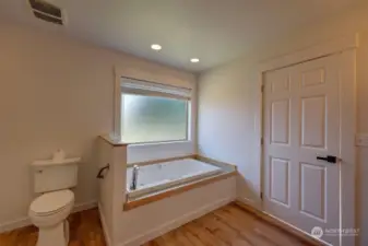 Primary suite with full bath, jetted tub, walk in shower and walk in closet.