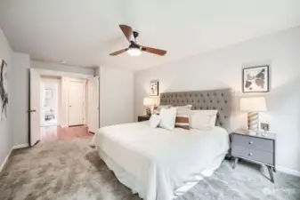 Oversized primary suite with ceiling fan and 5-piece bath.