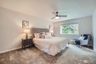 Oversized primary suite with ceiling fan and 5-piece bath.