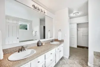 En suite bath with dual vanities, extra deep soaking tub and 2 closets.