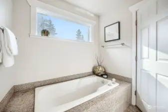 Extra deep soaking tub with granite surround.