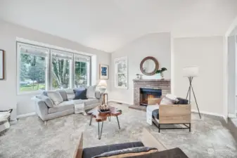 Sunken living room with wood-burning fireplace.