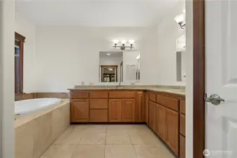 Primary Bath with dual sinks walk in shower and jetted tub.
