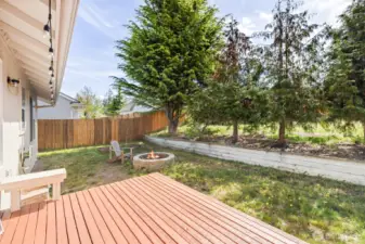 Backyard with firepit adjacent to Com. green space