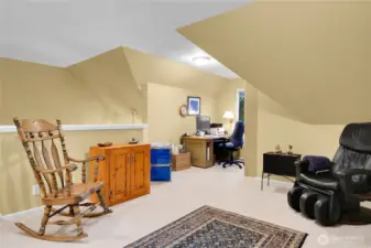 Upper level flex room with pony-wall overlook into the entry foyer, skylighted ceiling. Neutral carpet. Desk alcove with divided-light window and screen. Neutral carpet.