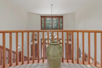 The upstairs hallway looks down into the entrance.