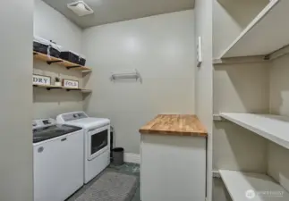 Large laundry room with storage.