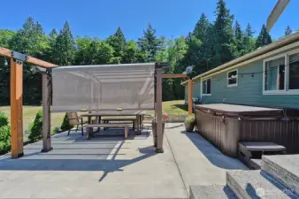 Gorgeous back patio with hot tub and more space to soak in the peacefulness of this property.
